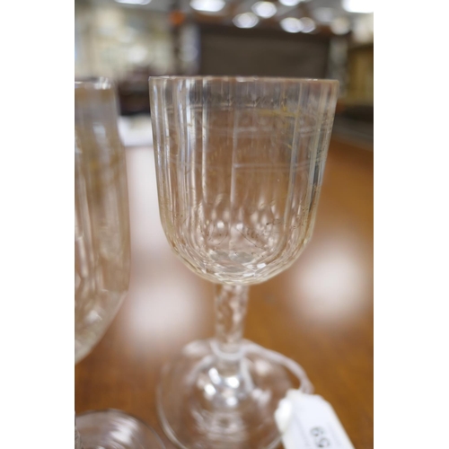 59 - Fifteen Regency gilded and faceted wine glasses, early 19th Century, the bowls decorated with ribbon... 