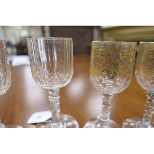 59 - Fifteen Regency gilded and faceted wine glasses, early 19th Century, the bowls decorated with ribbon... 