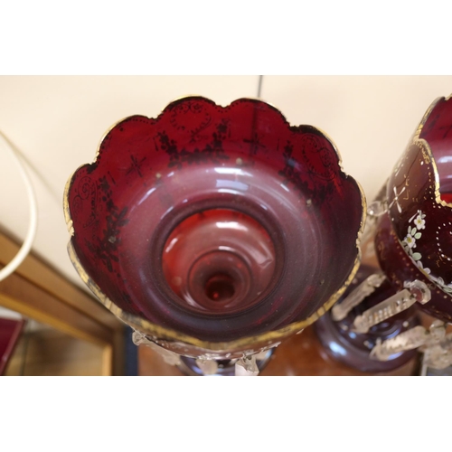 66 - Pair of Victorian ruby glass lustres, with crenellated tops enamelled with floral garlands and gilt ... 