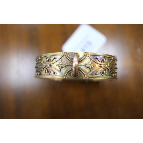 415 - Victorian gold coloured hinged bangle, circa 1880, worked with cannetille decoration, width 16mm, cu... 