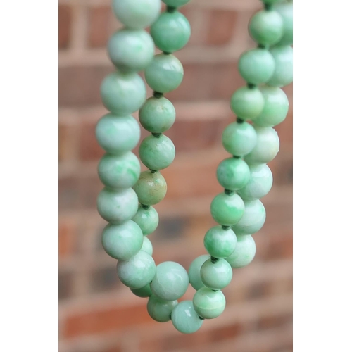 507 - Red coral bead necklace, 53cm; also a spinach green nephrite beaded necklace, 50cm; an apple green j... 