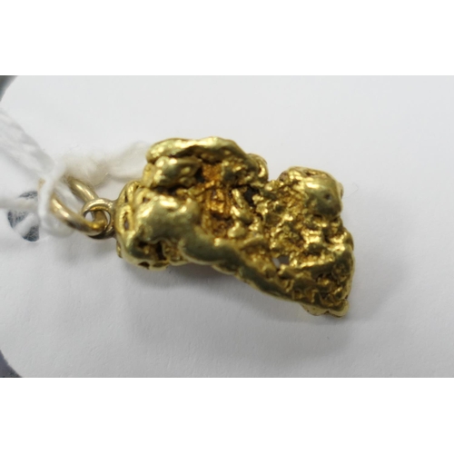 477 - Natural gold nugget, with an attached ring for suspension and a 9ct suspension ring, the nugget 18mm... 