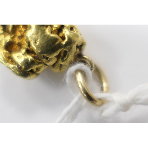 477 - Natural gold nugget, with an attached ring for suspension and a 9ct suspension ring, the nugget 18mm... 