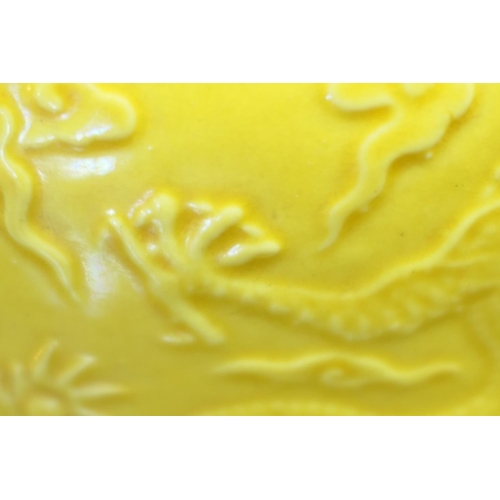 151 - Chinese yellow ground moulded dragon bowl, 20th Century, the dragons chasing a flaming pearl amidst ... 