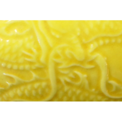 151 - Chinese yellow ground moulded dragon bowl, 20th Century, the dragons chasing a flaming pearl amidst ... 