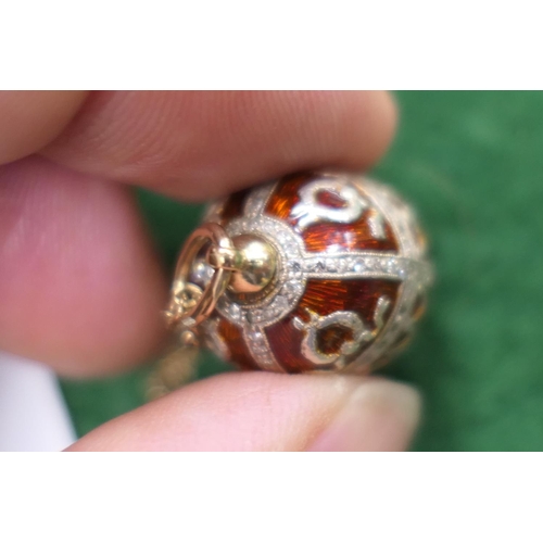 408 - Russian enamelled and diamond egg pendant, with deep red enamelled ground, worked in Imperialist sty... 