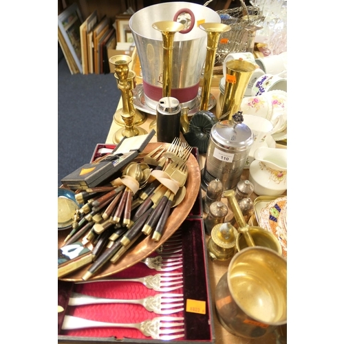 110 - Assorted cutlery, brass candlesticks, champagne bucket etc.