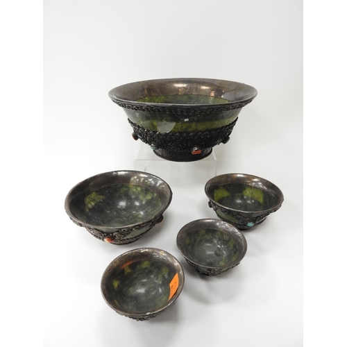 172 - Five Tibetan green nephrite and white metal mounted butter tea bowls set with semi-precious stones, ... 