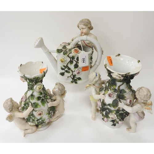 204 - Two German floral decanted cherub embellished vases, also a similar watering can (3)