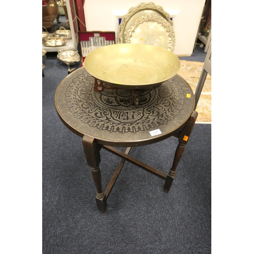 600 - Chinese brass bowl on stand; also a Middle Eastern calligraphic topped folding circular table (2)