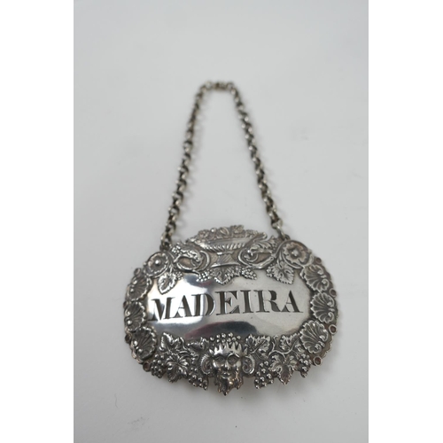 142 - William IV silver decanter label, pressed with grapes and a satyr, pierced 'Madeira', on a silver ch... 