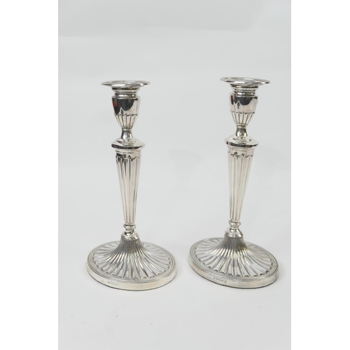 157 - Pair of modern silver candlesticks, London 1963, in the Adam style with urn shaped sconce, tapered o... 