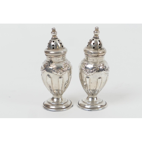 170 - Pair of Edwardian silver pepperettes, by Henry Matthews, Birmingham 1905, each of ovoid form worked ... 