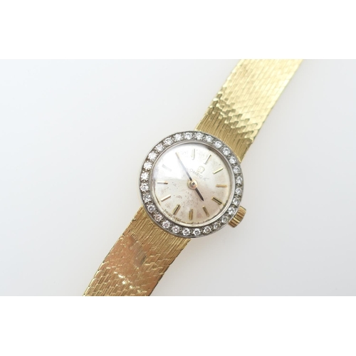 261 - Omega lady's 18ct gold and diamond cocktail watch, the circular champagne coloured dial with baton n... 