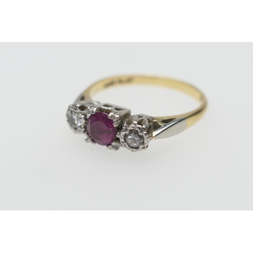 265 - Diamond and ruby three stone ring, the central round cut ruby of approx. 0.5ct, in a claw mount bord... 