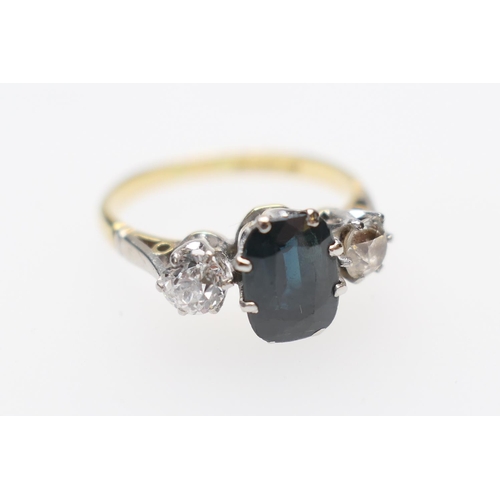 276 - Sapphire and diamond three stone ring, the oval cut sapphire 8mm x 6mm, flanked by two old round cut... 