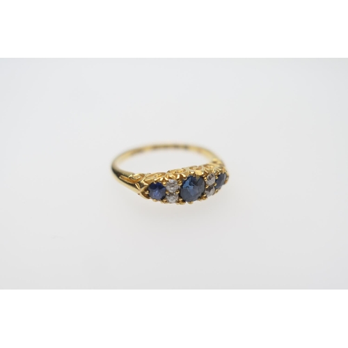 292 - Sapphire and diamond cluster ring, set with three round cut sapphires of good colour, dispersed with... 