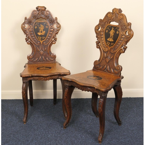 633 - Pair of Tyrolean carved walnut and inlaid hall chairs, late 19th Century, shaped carved backs centre... 