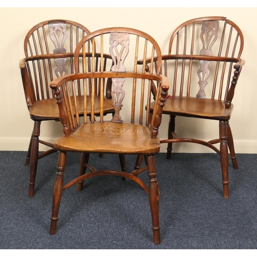 634 - Three yewood and ash low back Windsor armchairs, early 19th Century, each with crinoline stretcher