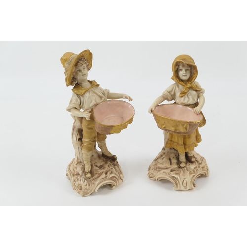 69 - Pair of Austrian porcelain figural table salts, circa 1900, modelled as a boy and girl, each support... 