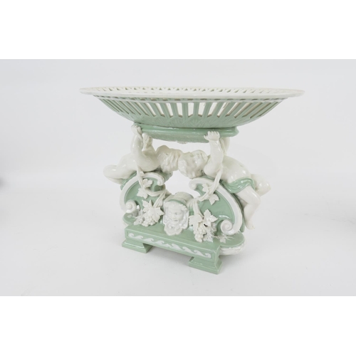 81 - Minton glazed parian table centrepiece, circa 1874, with an oval basket supported by reclining cheru... 