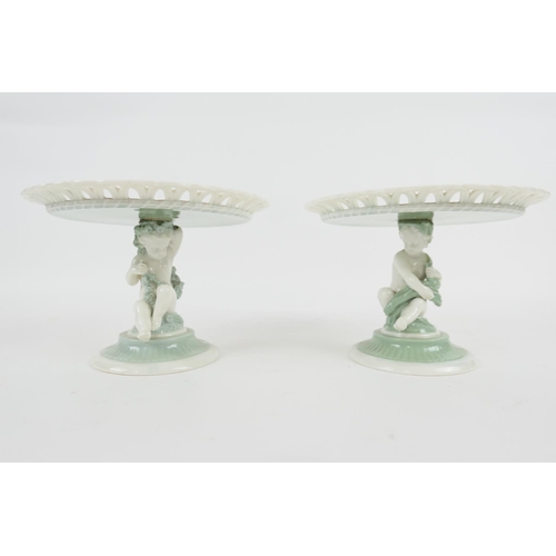 83 - Pair of Minton glazed parian figural comports, circa 1874, having a circular lattice bordered dish s... 