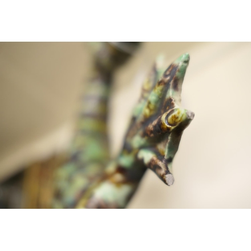 1 - Two Portuguese majolica lizard wall ornaments, one finished in speckled green and ochre, indistinctl... 