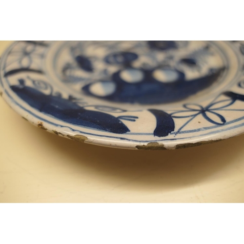 39 - Dutch delft plate, circa 1760, formal peony rock decoration in blue and white, 23.5cm diameter; also... 