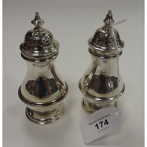 174 - Matched pair of silver pepper pots, one Charles Stuart Harris, London 1897, the other Birmingham 192... 