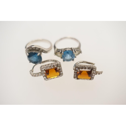 243 - Two decorative stone set dress rings in silver and a pair of paste set silver earrings (4)