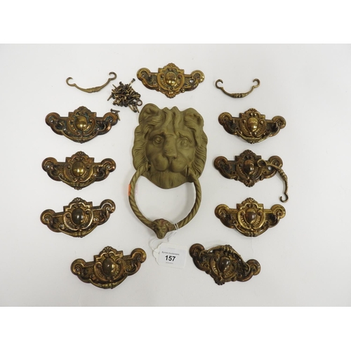 157 - Brass lion mask door knocker and a number of pressed brass furniture plates