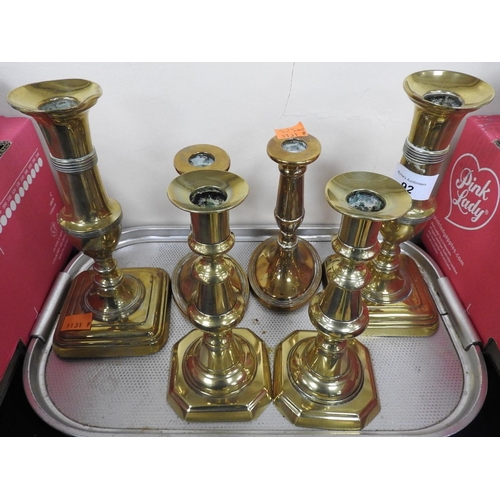 92 - Three pairs of brass candlesticks