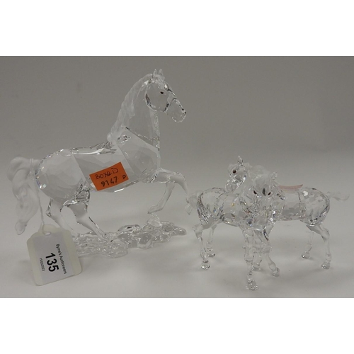 135 - Two Swarovski equine figures, the larger one complete with presentation box