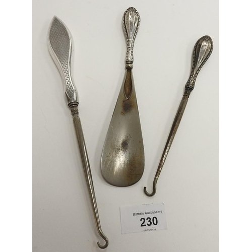 230 - Two silver  handled button hooks and a silver handled shoe horn