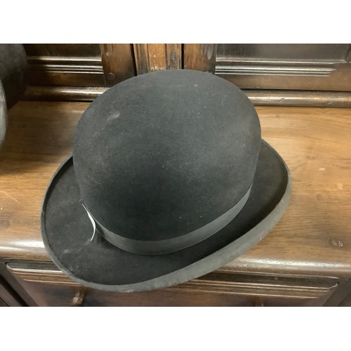 406 - Dunn & Co. top hat, with leather hat box, also a Dunn & Co. bowler hat (3)