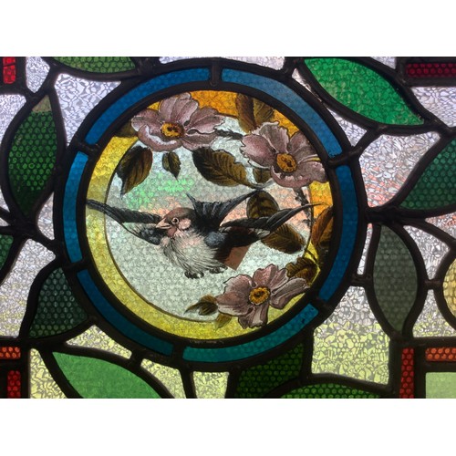 459 - Victorian Aesthetic period stained glass window panel centred with a flying sparrow, 39.5cm x 44cm