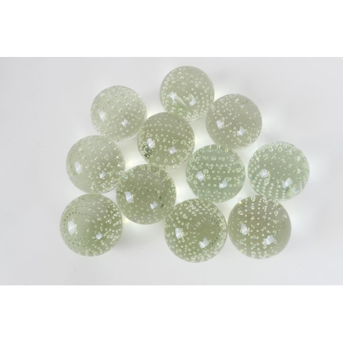 132 - Eleven glass spheres or carpet bowls, clear form punctuated with evenly spaced bubbles