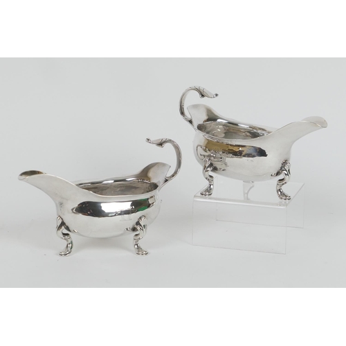 197 - Pair of Edwardian silver sauceboats, by William Comyns, London 1902, of good gauge, engraved with a ... 