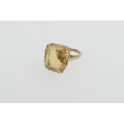 311 - Citrine dress ring, the stone untested, of cushion shape, 14mm x 12mm, on an unmarked yellow gold sp... 