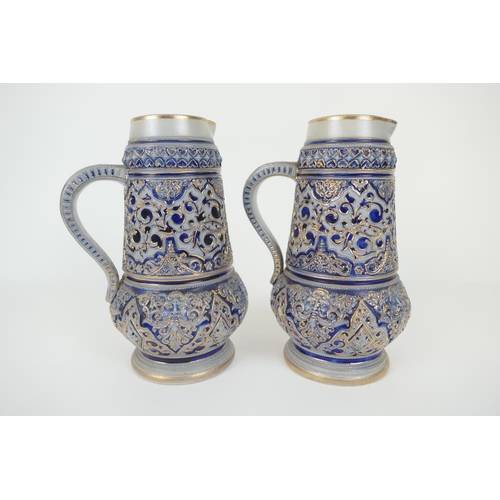 71 - Pair of Rhennish salt glazed stoneware ale jugs, tapered baluster form moulded with masks and detail... 