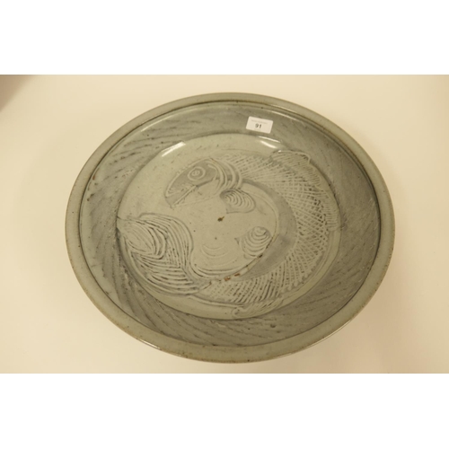 91 - Art Pottery large dish, sgraffito decorated with a fish under a crackle grey celadon glaze, 40cm dia... 