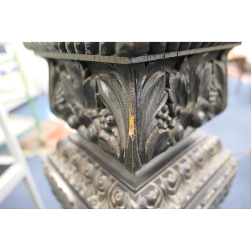 771 - Continental carved ebonised torchere, square plinth on an acanthus vine carved, tapered, square sect... 