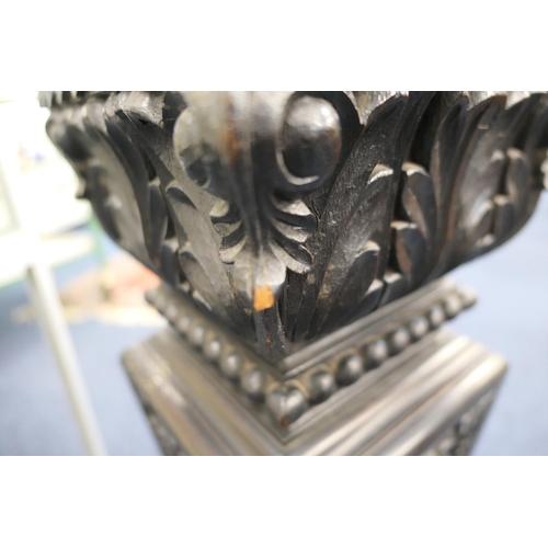 771 - Continental carved ebonised torchere, square plinth on an acanthus vine carved, tapered, square sect... 