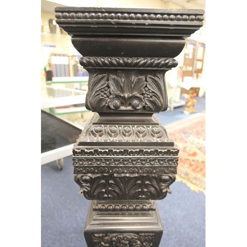 771 - Continental carved ebonised torchere, square plinth on an acanthus vine carved, tapered, square sect... 