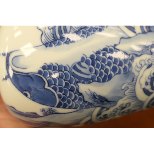 77 - Chinese blue and white bottle vase, 20th Century, decorated with a carp emerging from foaming waves,... 