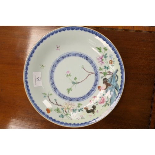 85 - Chinese famille rose plate, decorated with a cockerel and peony rock in colours, within an underglaz... 