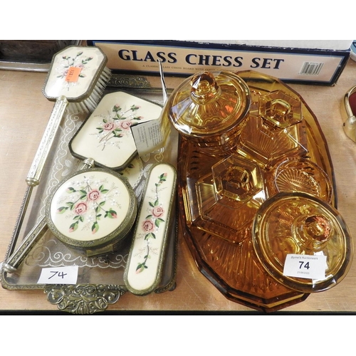 74 - Amber glass dressing table pieces including two trays, and a petit-point dressing table set