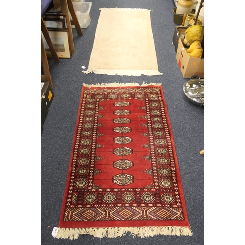 366 - Pakistan Bokhara red ground woollen rug, 130cm x 80cm; also a sculpted beige ground woollen rug, 160... 