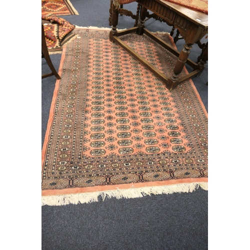 603 - Bokhara style salmon pink ground woollen carpet, 240cm x 160cm