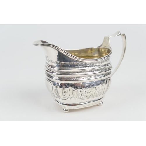 127 - George III silver milk jug, London 1809, helmet shaped with wrigglework decoration, raised on four b... 